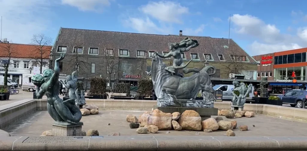 a statue of a woman riding a bull